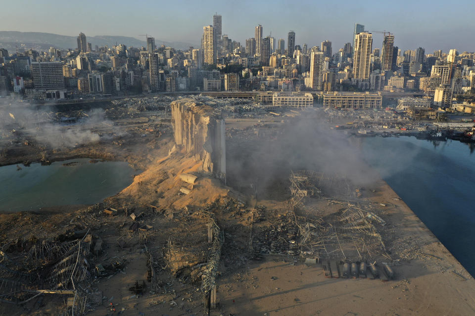 FILE - In this August 5, 2020 file photo, a drone picture shows the destruction after an explosion at the seaport of Beirut, Lebanon. The Lebanese judge leading the investigation into last year’s massive blast at Beirut’s port announced on Friday, July 2, 2021, he would pursue top politicians and former and current security officials in the case.(AP Photo/Hussein Malla, File)