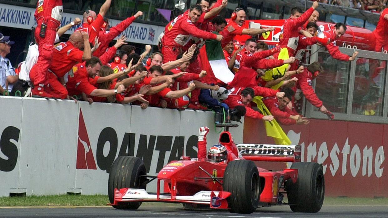 SCHUMACHER Ferrari driver Michael Schumacher of Germany is cheerd by his pit crew as he heads for the finish line to win the Australian Formula One Grand Prix in Melbourne, .