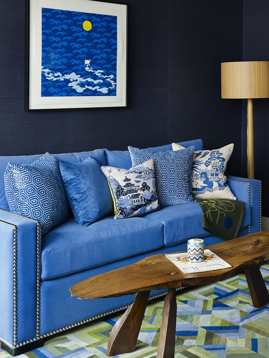 <p>Through natural wood elements and a dark wall color, blue accomplishes a different kind of look here: an upscale beach retreat. Design by <a href="https://deringhall.com/interior-designers/scott-sanders" rel="nofollow noopener" target="_blank" data-ylk="slk:Scott Sanders;elm:context_link;itc:0;sec:content-canvas" class="link ">Scott Sanders</a>.</p>