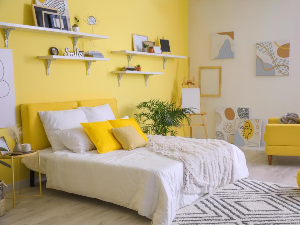 Yellow walls in bedroom with white bedding