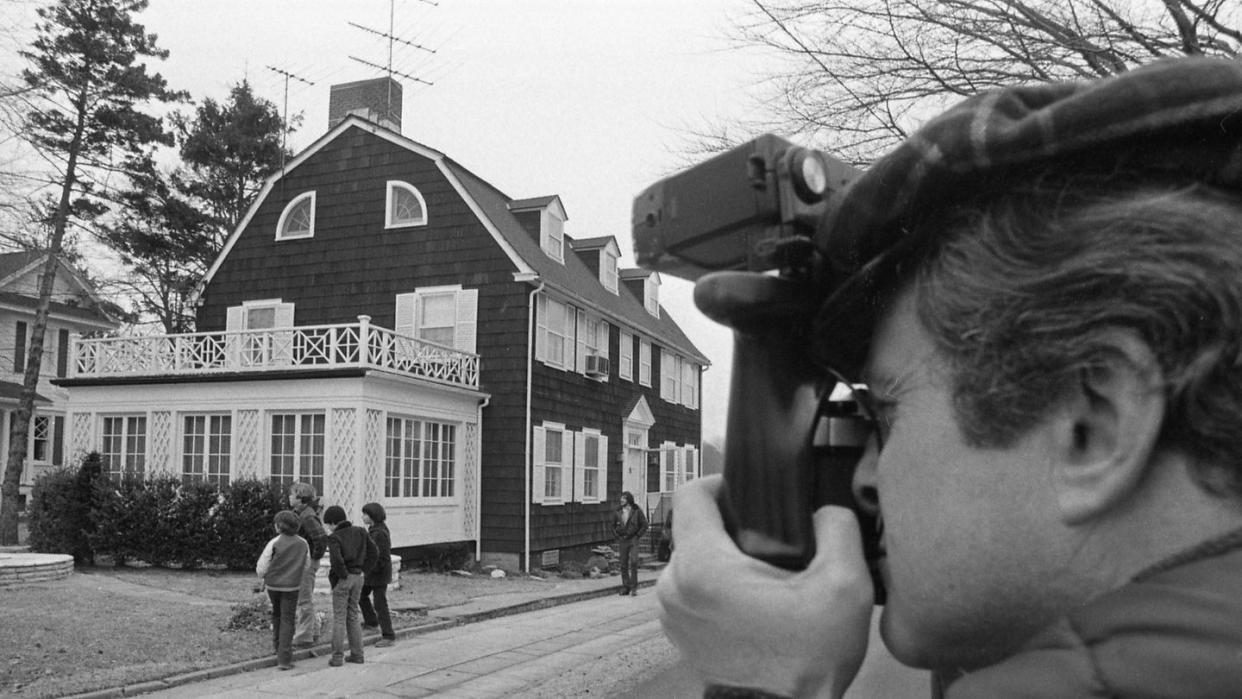 onlookers gather at amityville horror house on long island
