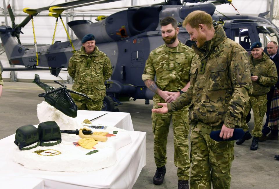 Harry checking out the cake&nbsp;made by British and Norwegian troops.&nbsp; (Photo: RUNE STOLTZ BERTINUSSEN / NTB SC via Getty Images)