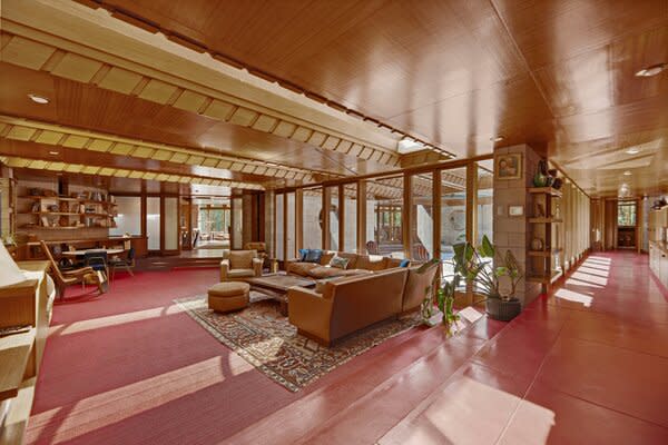 Red flooring lining the living areas pops against the mahogany trim and concrete walls.