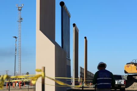 Four of U.S. President Donald Trump's eight border wall prototypes are shown near completion along U.S.- Mexico border in San Diego, California, U.S., October 23, 2017. REUTERS/Mike Blake