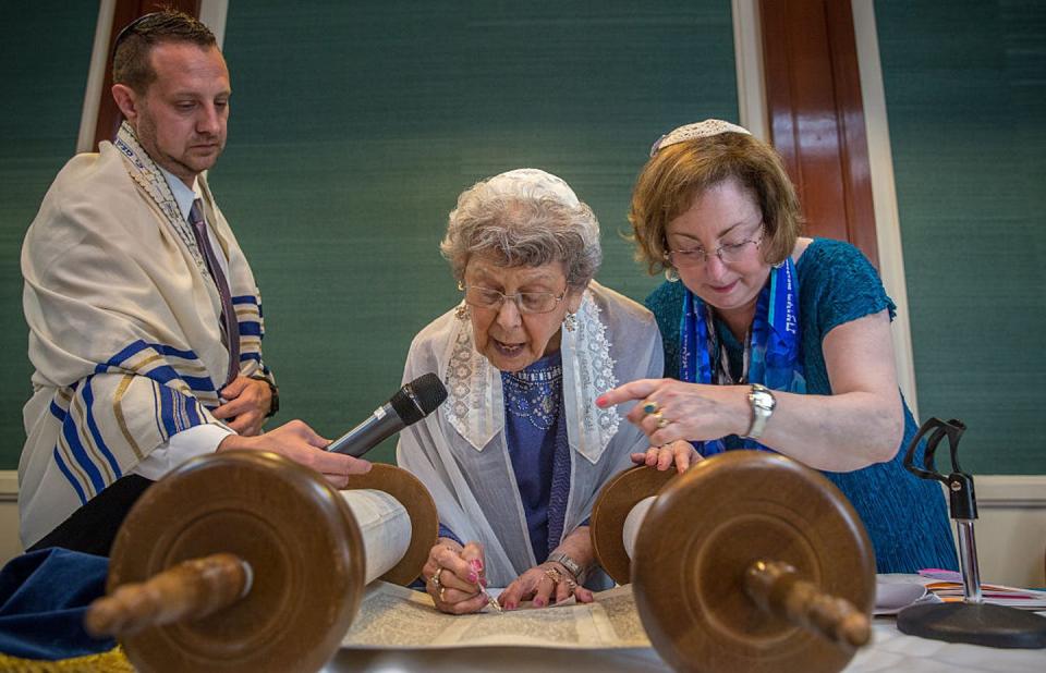 <span class="caption">Charlotte Gottlieb, 93, reads from the Torah during her bat mitzvah ceremony in Maryland. Women who were unable to have a ceremony at age 13 are now able to celebrate this Jewish ritual.</span> <span class="attribution"><a class="link " href="https://www.gettyimages.com/detail/news-photo/charlotte-gottlieb-reads-from-the-torah-during-her-bat-news-photo/531671170?adppopup=true" rel="nofollow noopener" target="_blank" data-ylk="slk:Evelyn Hockstein/For The Washington Post via Getty Images;elm:context_link;itc:0;sec:content-canvas">Evelyn Hockstein/For The Washington Post via Getty Images</a></span>