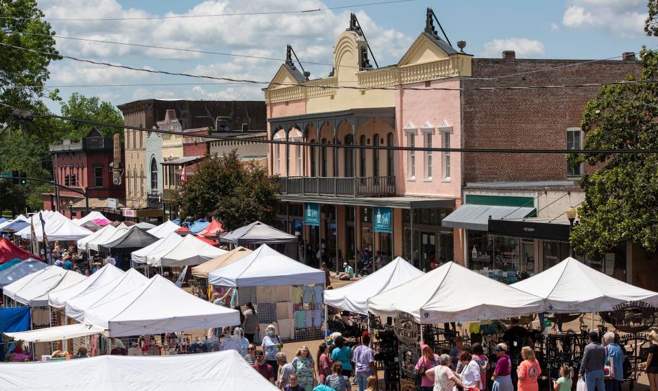 Canton Flea Market shoppers make their way through the booths on Union Street in Canton on Thursday, May 13, 2021. Although the crowd was smaller than usual, shoppers seemed to be buying. "I've done really well today," said Betty Sparrow of the Sparrow's Nest, from West Point.