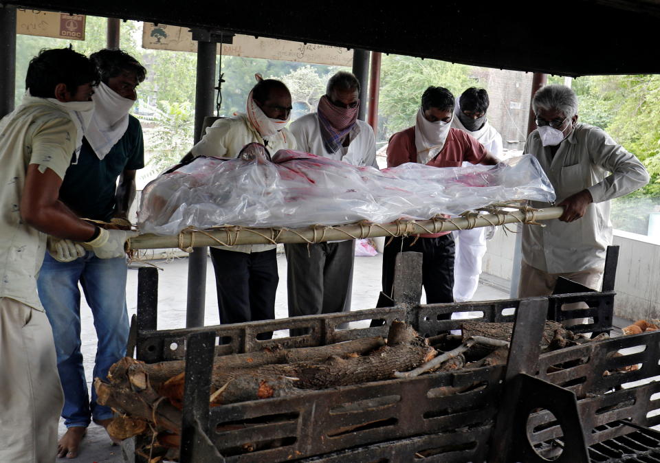  SENSITIVE MATERIAL. THIS IMAGE MAY OFFEND OR DISTURB    People prepare to cremate their relative, who died from the coronavirus disease (COVID-19), at a crematorium in Ahmedabad, India, June 10, 2021. REUTERS/Amit Dave