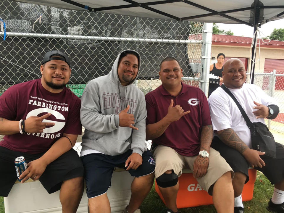 This 2017 photo provided by Ke'ala Aki shows from left to right, Farrington High School junior varsity football coaches Vale Masalosalo, Taleni Iiua, Kinohi Aki and Willie Talamoa, in Honolulu. A Honolulu community is mourning the loss of Talamoa, a mentor, football coach and father figure, who died after contracting COVID-19. (Ke'ala Aki via AP)