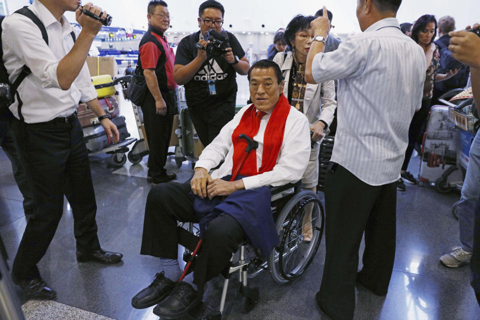 CORRECTS TO 1976, NOT 1979 - FILE - Japan's pro-wrestler-turned-parliamentarian Kanji "Antonio" Inoki prepares to leave Hong Kong on Sept. 7, 2018, for North Korea via Beijing, China. A popular Japanese professional wrestler and lawmaker Antonio Inoki, who faced a world boxing champion Muhammad Ali in a mixed martial arts match in 1976, has died at 79. The New Japan Pro-Wrestling Co. says Inoki, who was battling an illness, died earlier Saturday, Oct. 1, 2022. (AP Photo/Kin Cheung, File)