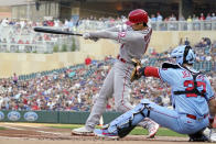 Los Angeles Angels' Shohei Ohtani, left, follows through on a double off Minnesota Twins pitcher Jose Berrios in the first inning of a baseball game, Saturday, July 24, 2021, in Minneapolis. (AP Photo/Jim Mone)