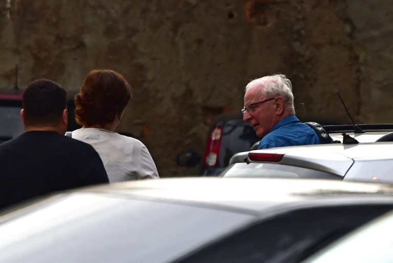 International Olympic Committee (IOC) member Patrick Hickey (R) arrives at the police station after being arrested on allegations of taking part in a black market ticket ring, on August 18, 2016, in Rio de Janeiro, Brazil