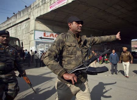 An Indian security personnel asks people to move away from the area outside the Indian Air Force (IAF) base at Pathankot in Punjab, January 3, 2016. REUTERS/Mukesh Gupta