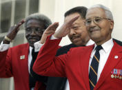 FILE- From left, Tuskegee Airmen, Cicero Satterfield, left, Lucius Theus, center, and Charles McGee, right, salute while posing for a group photo on the steps of the Capitol during a ceremony kicking off a nationwide fundraising drive for a memorial to the Tuskegee Airmen, Monday Dec. 18, 2006, in Montgomery, Ala. McGee, one of the last surviving Tuskegee Airmen who flew 409 fighter combat missions over three wars, died Sunday, Jan. 16, 2022. He was 102. (AP Photo/Rob Carr, File)