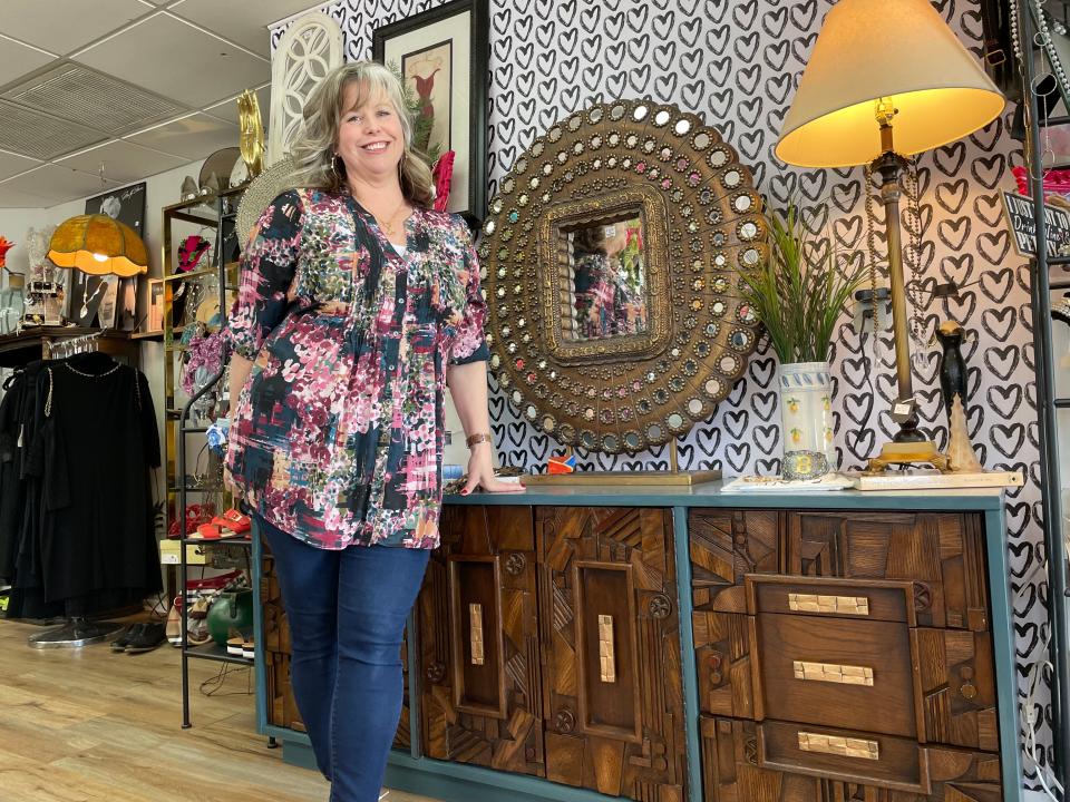 Brandy Wimmer shows off some of her favorite furnishings currently for sale at her new consignment store The Garment District Resale in downtown Howell, Tuesday, March 14, 2023.