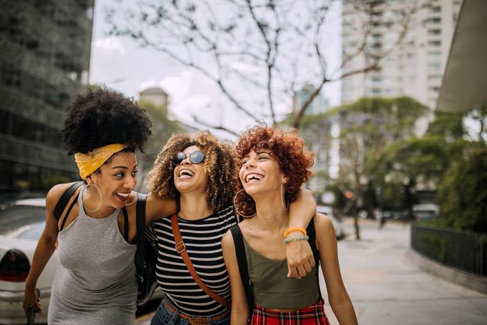 group of women laughing on the sidewalk