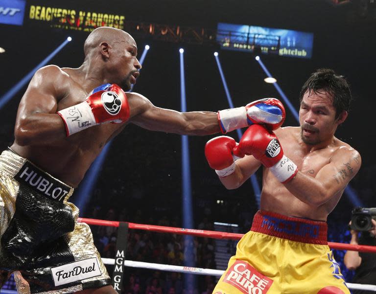 Floyd Mayweather exchanges punches with Manny Pacquiao during their welterweight unification championship bout on May 2, 2015 at MGM Grand Garden Arena