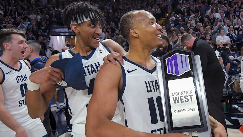 Utah State guard Landon Brenchley (0), guard Ian Martinez, and guard Darius Brown II, right, celebrate after the team's win over New Mexico Saturday, March 9, 2024, in Logan, Utah. The victory clinched the Mountain West Conference regular-season championship for Utah State. (Eli Lucero/The Herald Journal via AP)