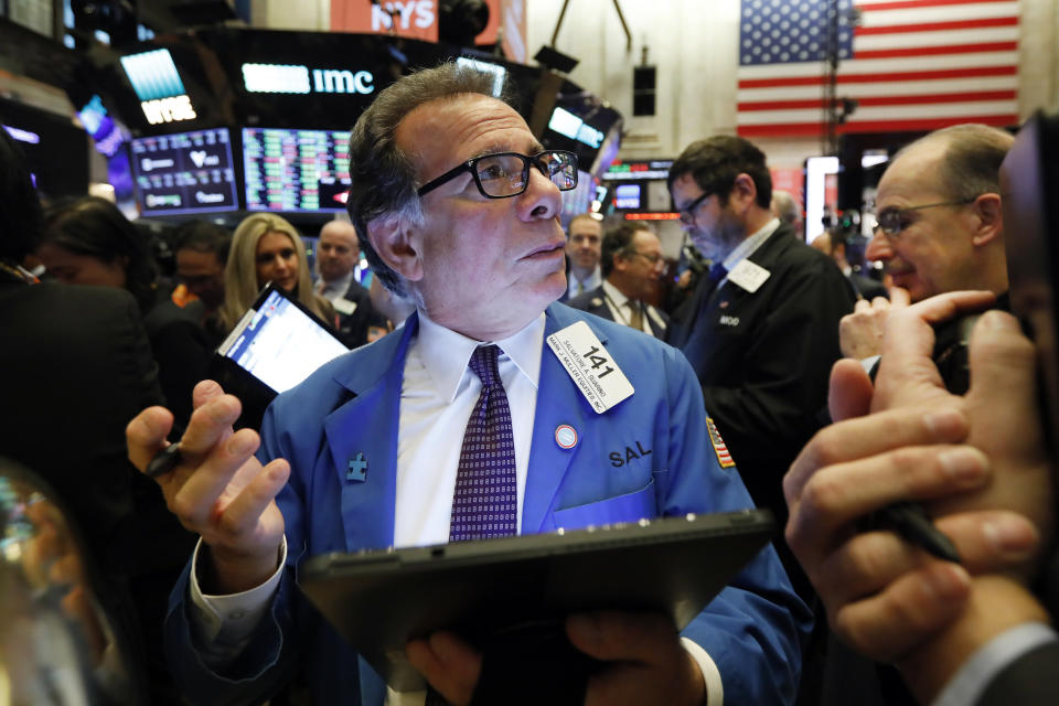 Trader Sal Suarino works on the floor of the New York Stock Exchange, Friday, Dec. 13, 2019. After months of waiting, markets had a muted reaction to news Friday that the US and China had reached an initial deal on trade. (AP Photo/Richard Drew)