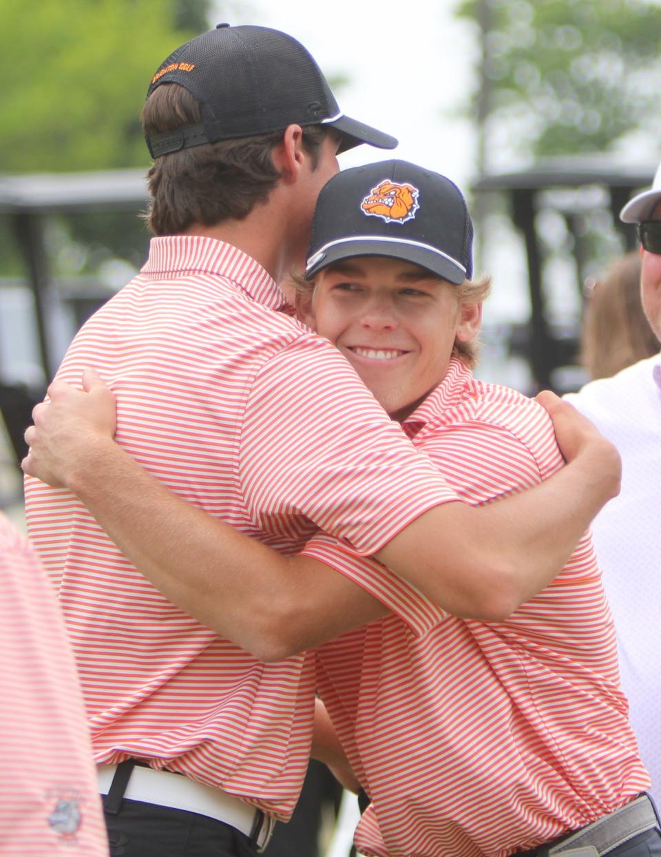 Brighton seniors Winston Lerch (right) and Andrew Daily embrace following the final rounds of their high school careers Saturday, June 10, 2023 at The Meadows in Allendale.