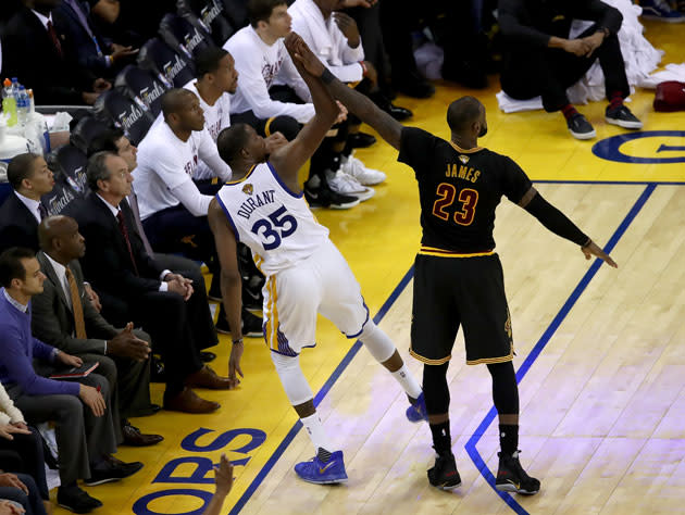 Kevin Durant and LeBron James meet between the lines. (Getty Images)