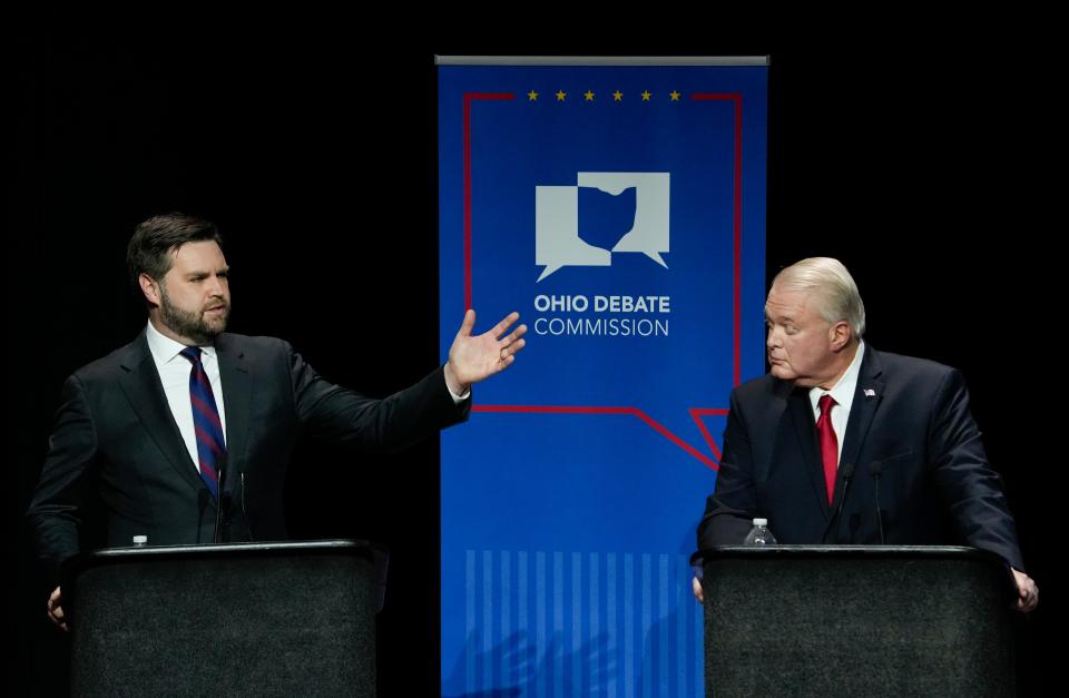 U.S. Senate Republican candidate J.D. Vance, left, makes a point as fellow candidate Mike Gibbons listens during Ohio’s U.S. Senate Republican Primary Debate at Central State University. Joshua A. Bickel/Ohio Debate Commission