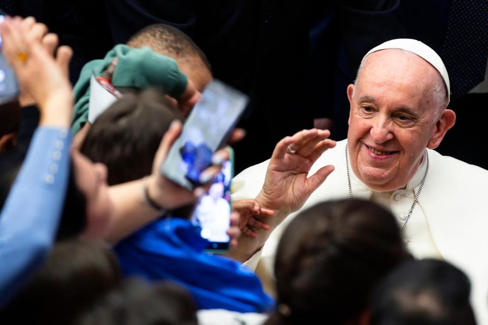 Pope Francis meets families during an audience for refugee families that came to Italy through the humanitarian corridors, in the Paul VI Hall at the Vatican (EPA)