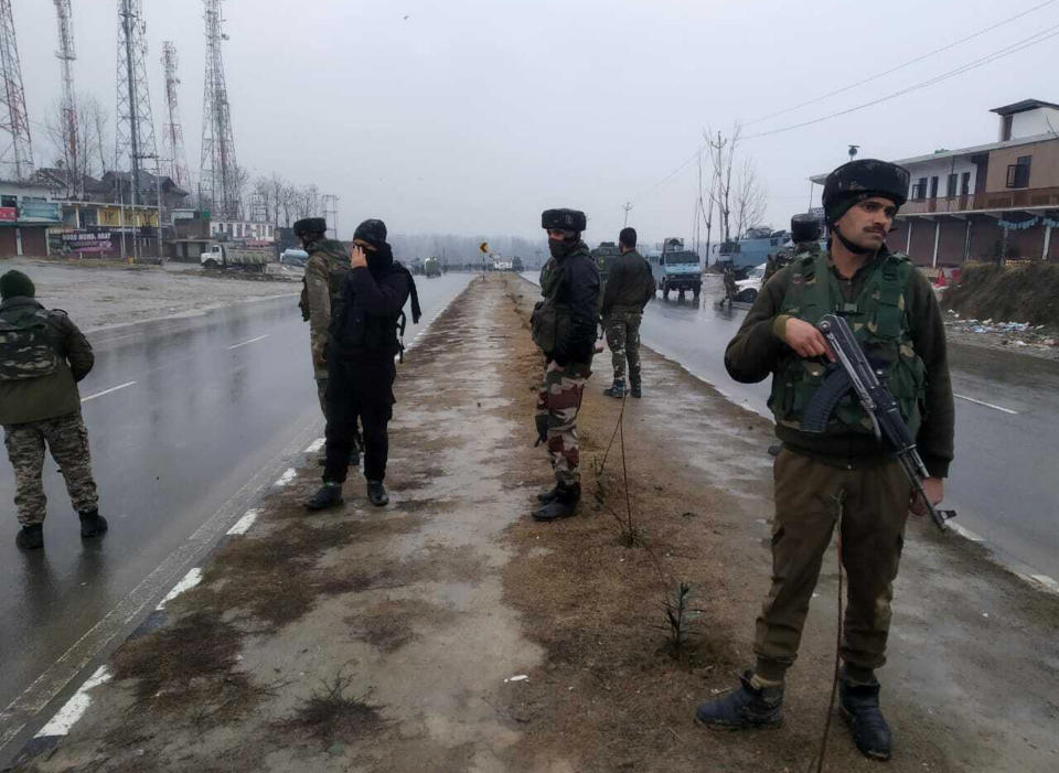 Indian paramilitary soldiers patrol near the site of an explosion in Pampore, Indian-controlled Kashmir, Thursday, Feb. 14, 2019. Security officials say at least 10 soldiers have been killed and 20 others wounded by a large explosion that struck a paramilitary convoy on a key highway on the outskirts of the disputed region's main city of Srinagar. (AP Photo/Dar Yasin)