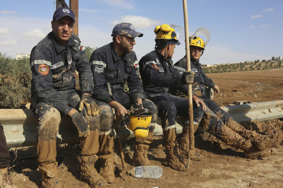 Jordanian rescue teams searched Saturday, Nov. 10, 2018 for missing people in the Madaba area, south of the capital of Amman, after flash floods unleashed by heavy rain a day earlier killed several people. (AP Photo/Raad Adayleh)