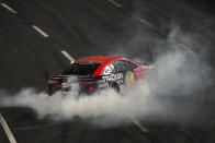 NASCAR Cup Series driver Martin Truex Jr. (19) burns out after winning a NASCAR exhibition auto race at Los Angeles Memorial Coliseum, Sunday, Feb. 5, 2023, in Los Angeles. (AP Photo/Ashley Landis)