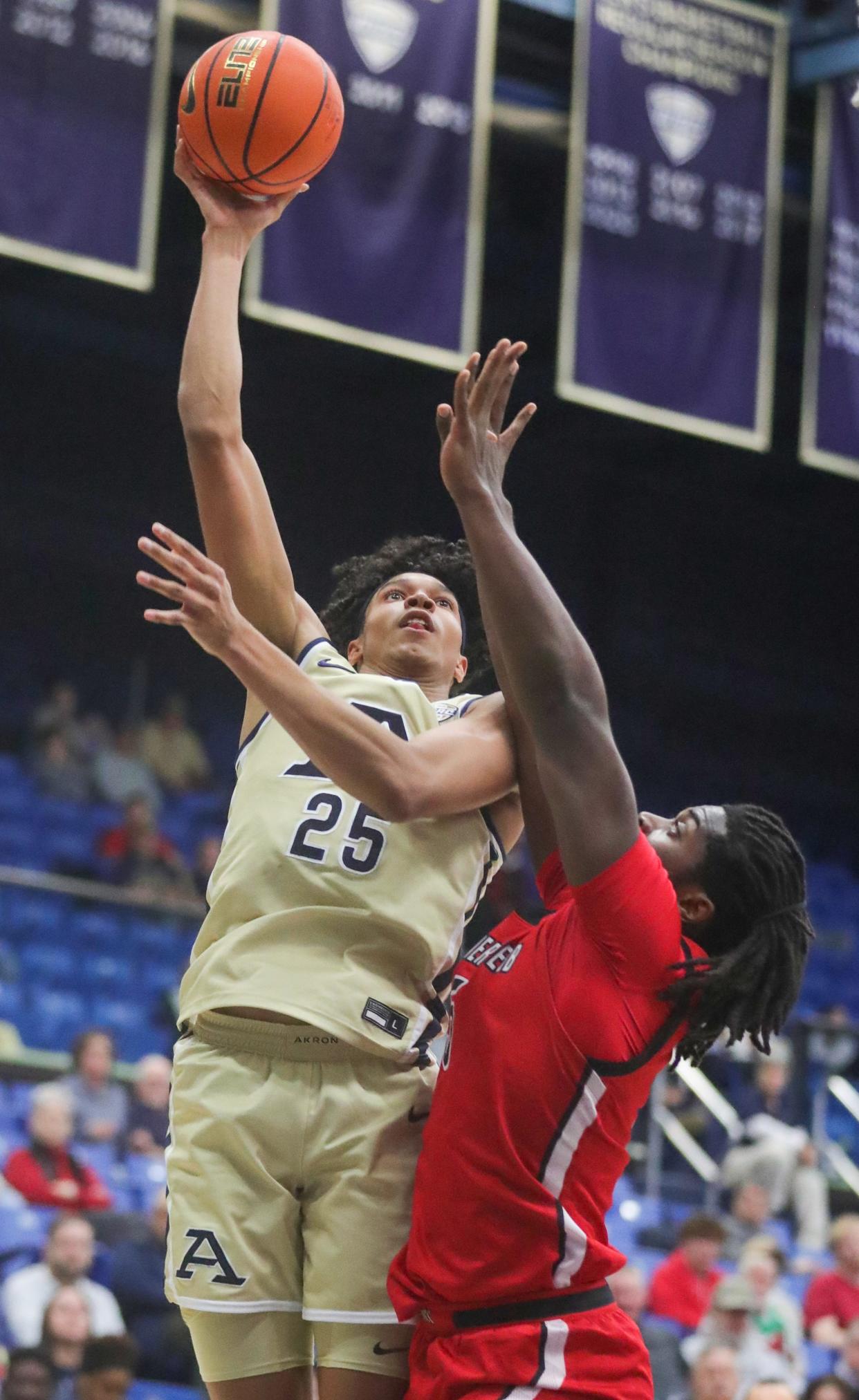 University of Akron's Enrique Freeman puts up a shot over Gardner-Webb's Ademide Badmus on Thursday, Dec. 21, 2023, in Akron, Ohio. [Phil Masturzo/ Beacon Journal]