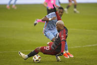 Toronto FC midfielder Deybi Flores (20) and New York City FC midfielder Andrés Perea (8) vie for control of the ball during the first half of an MLS soccer match Saturday, May 11, 2024, in Toronto. (Frank Gunn/The Canadian Press via AP)
