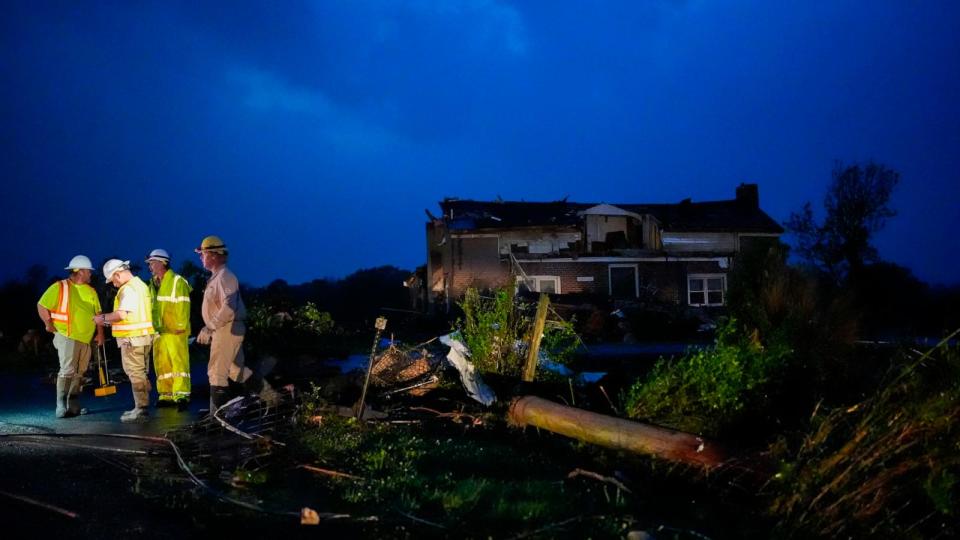 PHOTO: Utility workers survey storm damage along Cothran Road, Wednesday, May 8, 2024, in Columbia, Tennessee. (George Walker IV/AP)