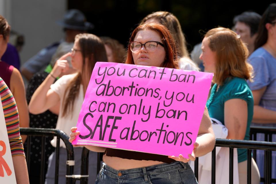 An abortion-rights supporter holds a sign outside the South Carolina Statehouse on Thursday, July 7, 2022, in Columbia, S.C. Protesters clashed outside a legislative building, where lawmakers were taking testimony as they consider new restrictions on abortion in the wake of the U.S. Supreme Court's decision overturning of Roe v. Wade. (AP Photo/Meg Kinnard)