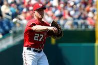Aug 23, 2015; Washington, DC, USA; Washington Nationals starting pitcher Jordan Zimmermann (27) makes a throwing error while throwing to first base against the Milwaukee Brewers in the fourth inning at Nationals Park. The Nationals won 9-5. Mandatory Credit: Geoff Burke-USA TODAY Sports