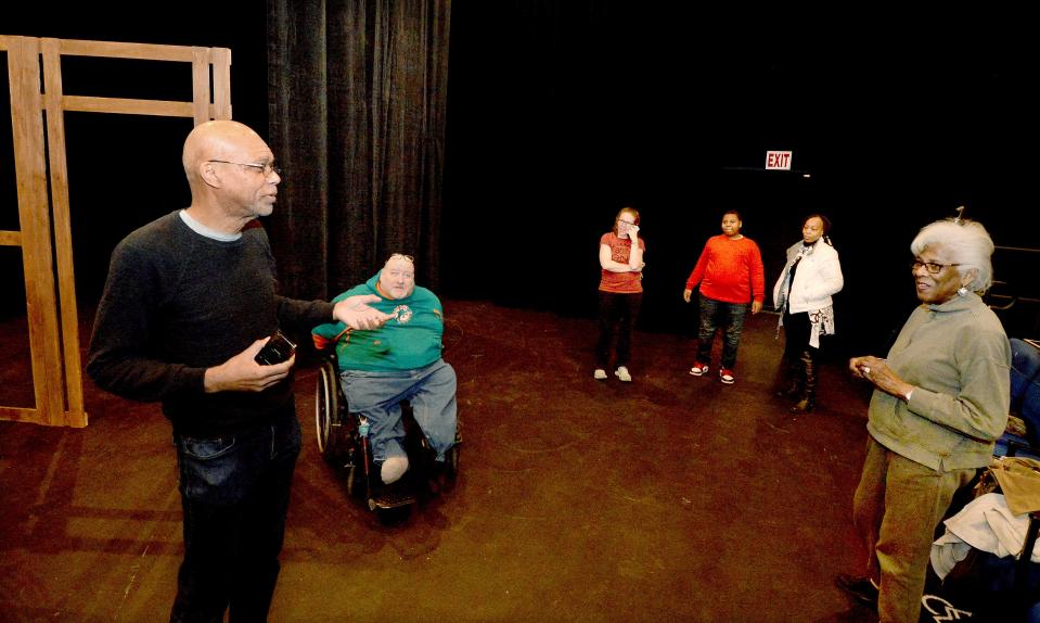Tim Crawford, left, of Our Stage/Our Voices artist-in-residence at University of Illinois Springfield Performing Arts Center, talks to cast members and backstage crew members before a rehearsal of the play "Outraged: Terror in Springfield 1908" on Monday. Crawford wrote the plays and directs the production, which will be staged Friday through Sunday at the UIS Studio Theatre.