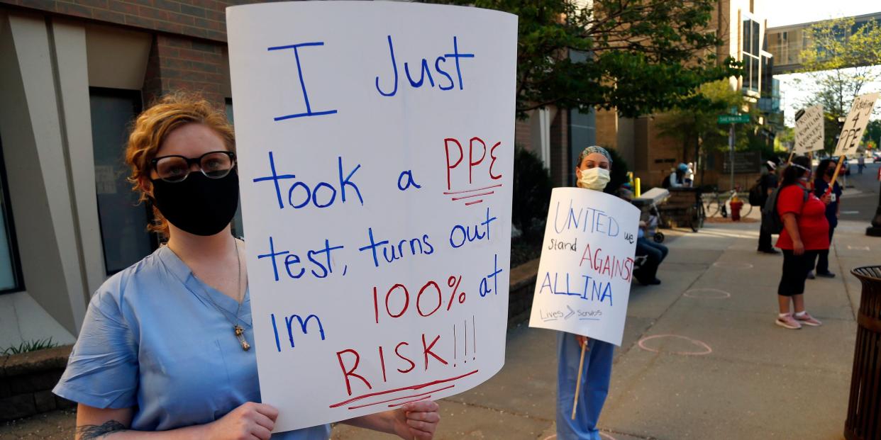 Nurses picket outside United Hospital Wednesday, May 20, 2020 in St. Paul, Minn. as they seek a say in worker protections, increased personal protection resources with higher safety standards, and an end to retaliation against workers who have tried to protect themselves from COVID-19. (AP Photo/Jim Mone)