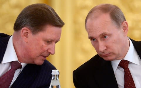 Then chief-of-staff Sergei Ivanov speaks with Vladimir Putin in 2014 - Credit: Alexei Nikolsky/AP