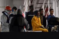 Rescued migrants off the Libyan coast arrive at the harbor in Catania, Italy on April 20, 2015