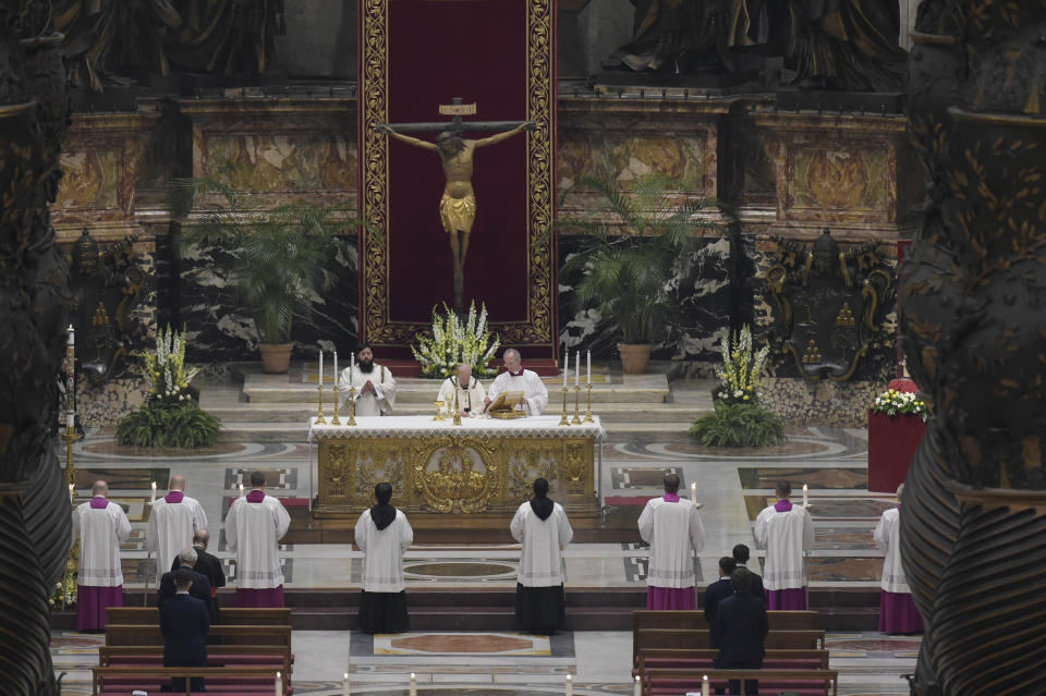 Pope Francis presides over a solemn Easter vigil ceremony in St. Peter's Basilica empty of the faithful following Italy’s ban on gatherings to contain coronavirus contagion, at the Vatican, Saturday, April 11, 2020. The new coronavirus causes mild or moderate symptoms for most people, but for some, especially older adults and people with existing health problems, it can cause more severe illness or death. (Vatican News via AP)