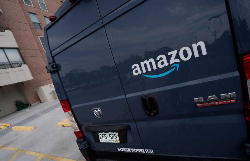 The company logo graces one of the doors of a delivery van for Amazon Wednesday, Sept. 1, 2021, in Denver.