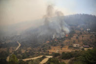 The smoke-engulfed Mazi area engulfed by wildfires, forcing people to be evacuated, in Bodrum, Mugla, Turkey, Sunday, Aug. 1, 2021. More than 100 wildfires have been brought under control in Turkey, according to officials. The forestry minister tweeted that five fires are continuing in the tourist destinations of Antalya and Mugla. (AP Photo/Emre Tazegul)