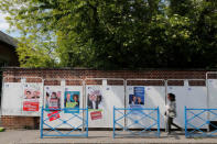 A woman walks past official European election posters in a street in Amiens, France, May 16, 2019. REUTERS/Pascal Rossignol