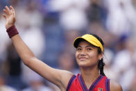 Emma Raducanu, of Britain, waves to the crowd after winning her match against Shelby Rogers, of the United States, in the fourth round of the US Open tennis championships, Monday, Sept. 6, 2021, in New York. (AP Photo/Seth Wenig)