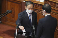 Yoshihide Suga, left, drops his ballet in a parliamentary vote at the parliament's lower house in Tokyo, Wednesday, Sept. 16, 2020. Suga was formally elected Wednesday as Japan's new prime minister in the vote, replacing Shinzo Abe. (AP Photo/Koji Sasahara)