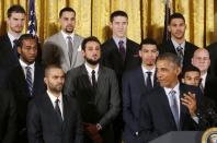 Members of the 2014 NBA Champion San Antonio Spurs listen to U.S. President Barack Obama as he welcomes the team to the East Room of the White House in Washington, January 12, 2015. REUTERS/Larry Downing (UNITED STATES - Tags: POLITICS SPORT BASKETBALL)