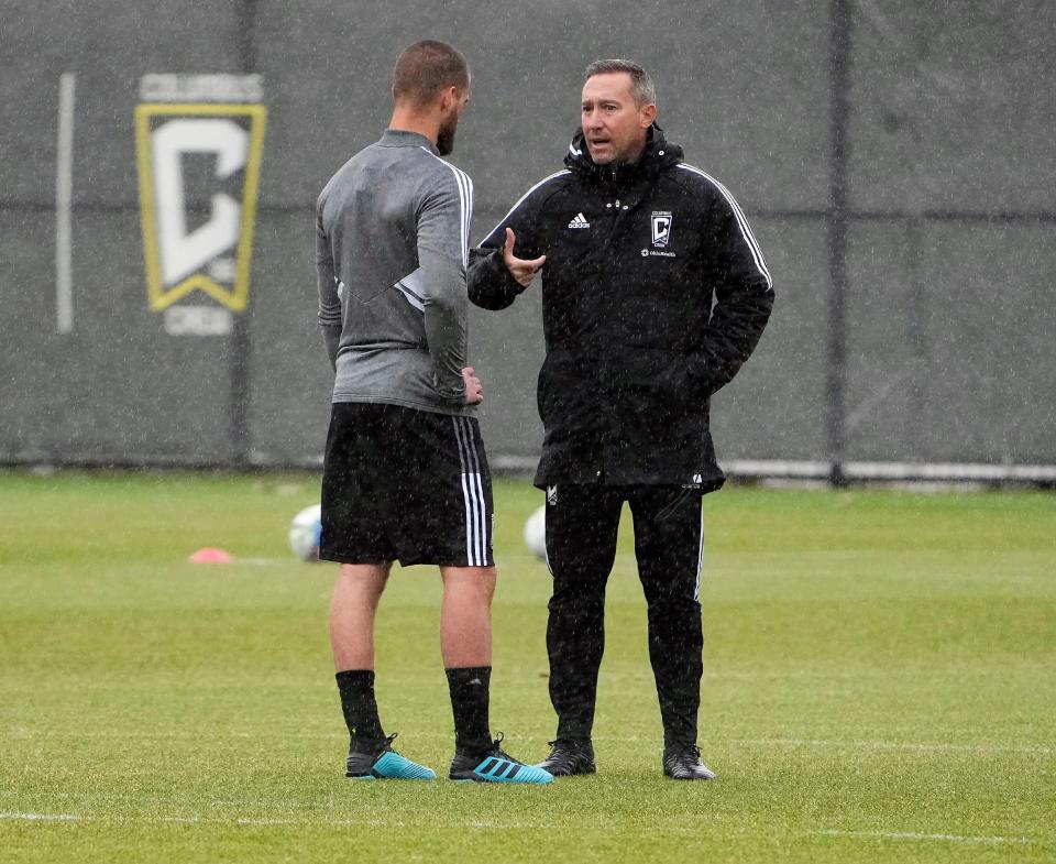 Columbus Crew head coach Caleb Porter talks to Perry Kitchen before the start of practice at Columbus Crew training facility in Columbus, Ohio on February 22, 2022. 