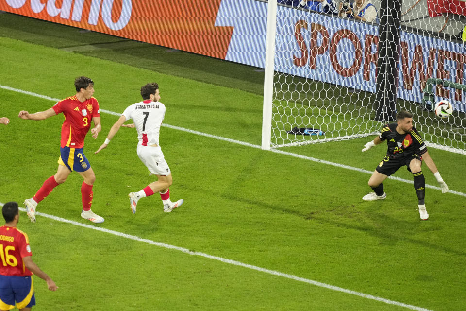 Spain's Robin Le Normand, left, scores an own goal during a round of sixteen match between Spain and Georgia at the Euro 2024 soccer tournament in Cologne, Germany, Sunday, June 30, 2024. (AP Photo/Andreea Alexandru)