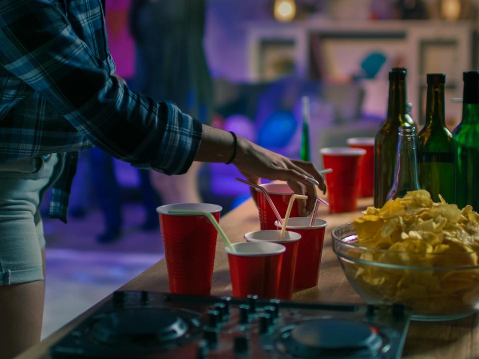 college party drinks in sippy cup on table