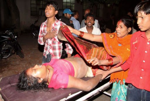 A victim of the stampede is rushed to hospital after a bamboo bridge collapsed during Chhat Puja on the banks of the Ganges River in Patna on November 19, 2012. Patna police superintendent Jayant Kant said that a total of 18 people were confirmed dead -- 10 women and eight children -- but that the toll was likely to rise as several other devotees were reported missing at the site