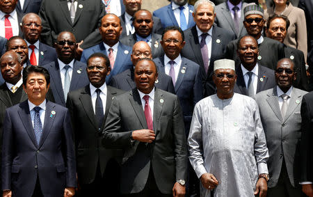 Japan's Prime Minister Shinzo Abe (L) joins African leaders for a group photograph during a break session for the Sixth Tokyo International Conference on African Development (TICAD VI) in Kenya's capital Nairobi, August 27, 2016. Pictured beside Abe are (bottom L-R): Equatorial Guinea's President Teodoro Obiang Nguema Mbasogo, Kenya's President Uhuru Kenyatta, Chad's President Idriss Deby, and Zimbabwe's President Robert Mugabe. REUTERS/Thomas Mukoya